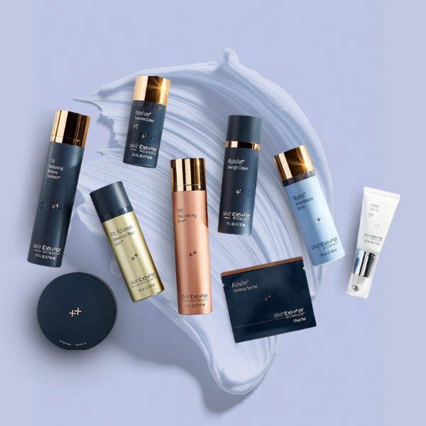 Assorted skincare bottles, a compact, and a box arranged on a pale blue background with a swirl of cream.
